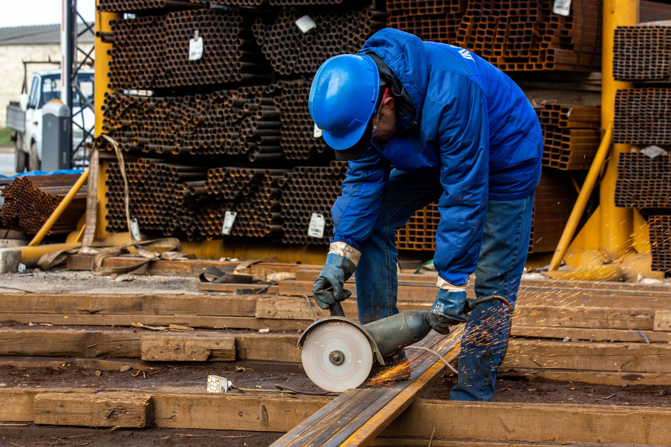 Steel worker cutting metal